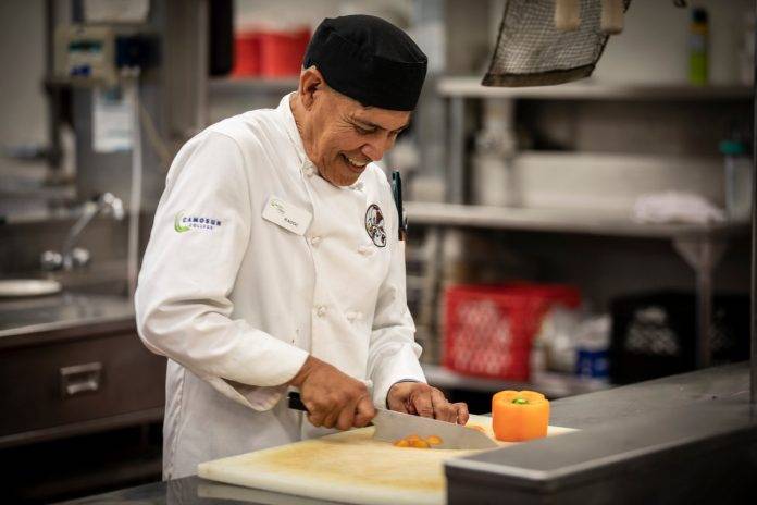 Indigenous student preparing food in the kitchen at Camosun College.