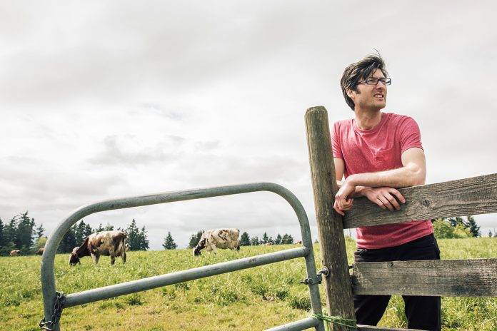 farmer in a field with cows